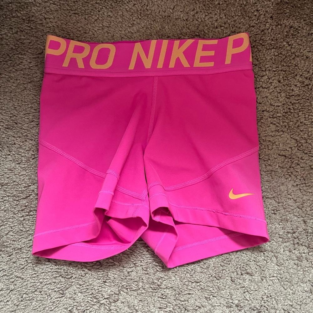 Pink and orange Nike pros
